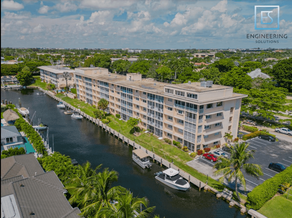 A large building with boats in the water.