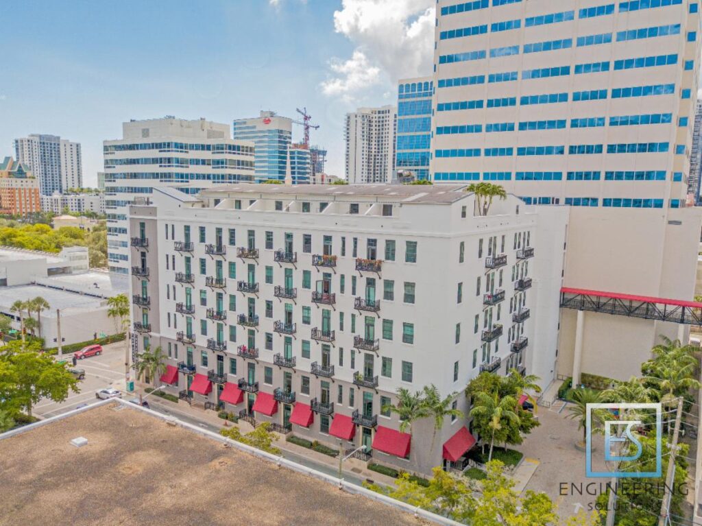 A building with many windows and red awnings.