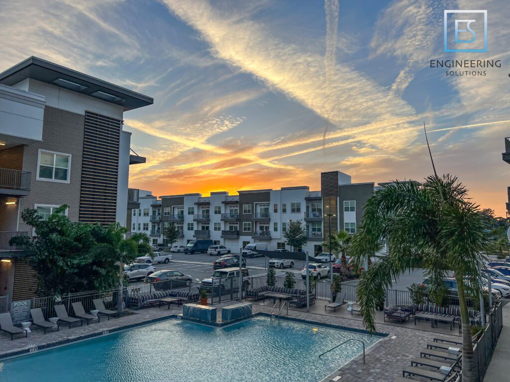 A pool with an outdoor bar and lounge chairs.