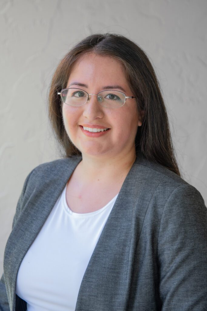 A woman with glasses and a jacket on