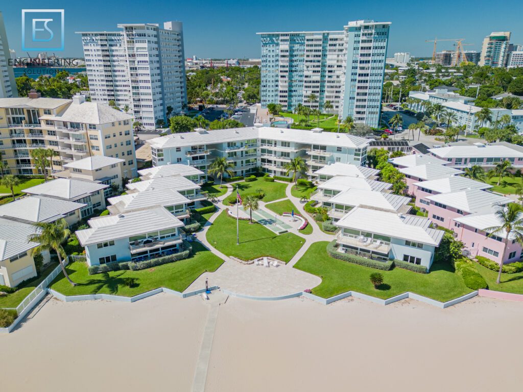 A view of the beach from above shows many buildings.