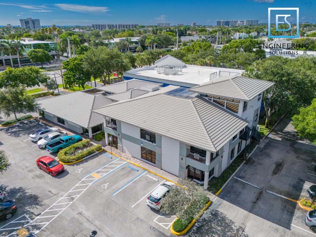 A parking lot with cars parked in front of it.