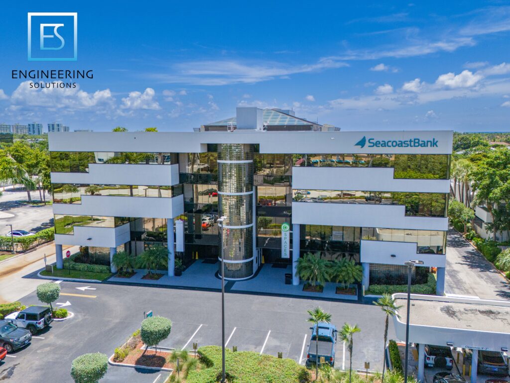A building with many windows and trees in the background