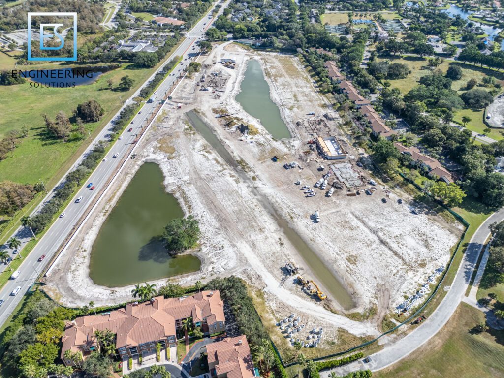 An aerial view of a construction site with water.
